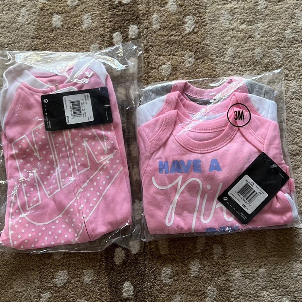 Nike baby pink 3mo zip footie and 3-pack button onesies with long sleeves